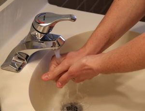 washing hands over a sink